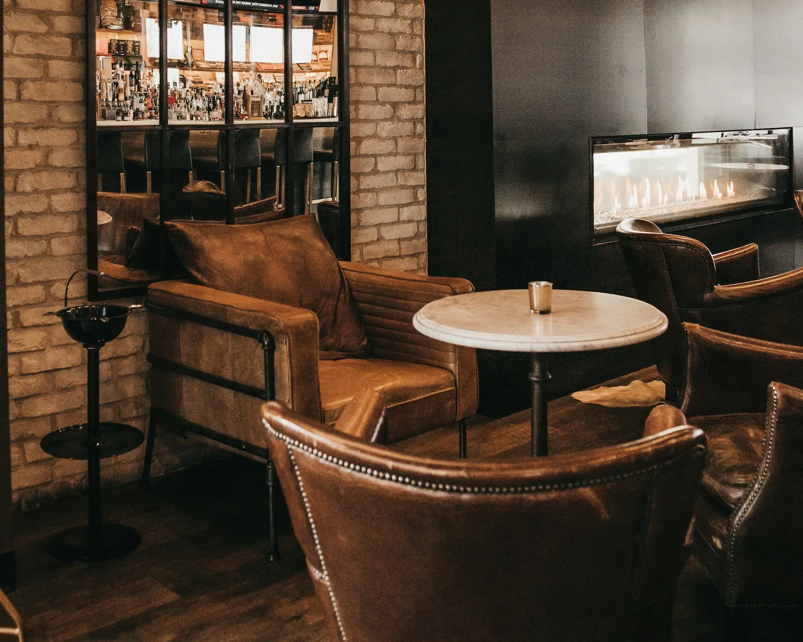 Leather chairs in a warm, softly lit cigar lounge
