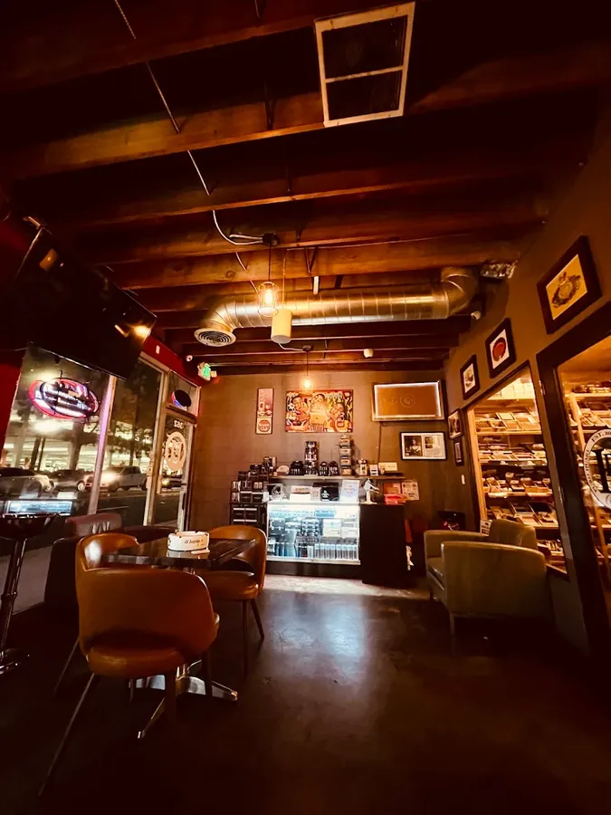 Leather chairs and the counter at Puro Humo in the evening